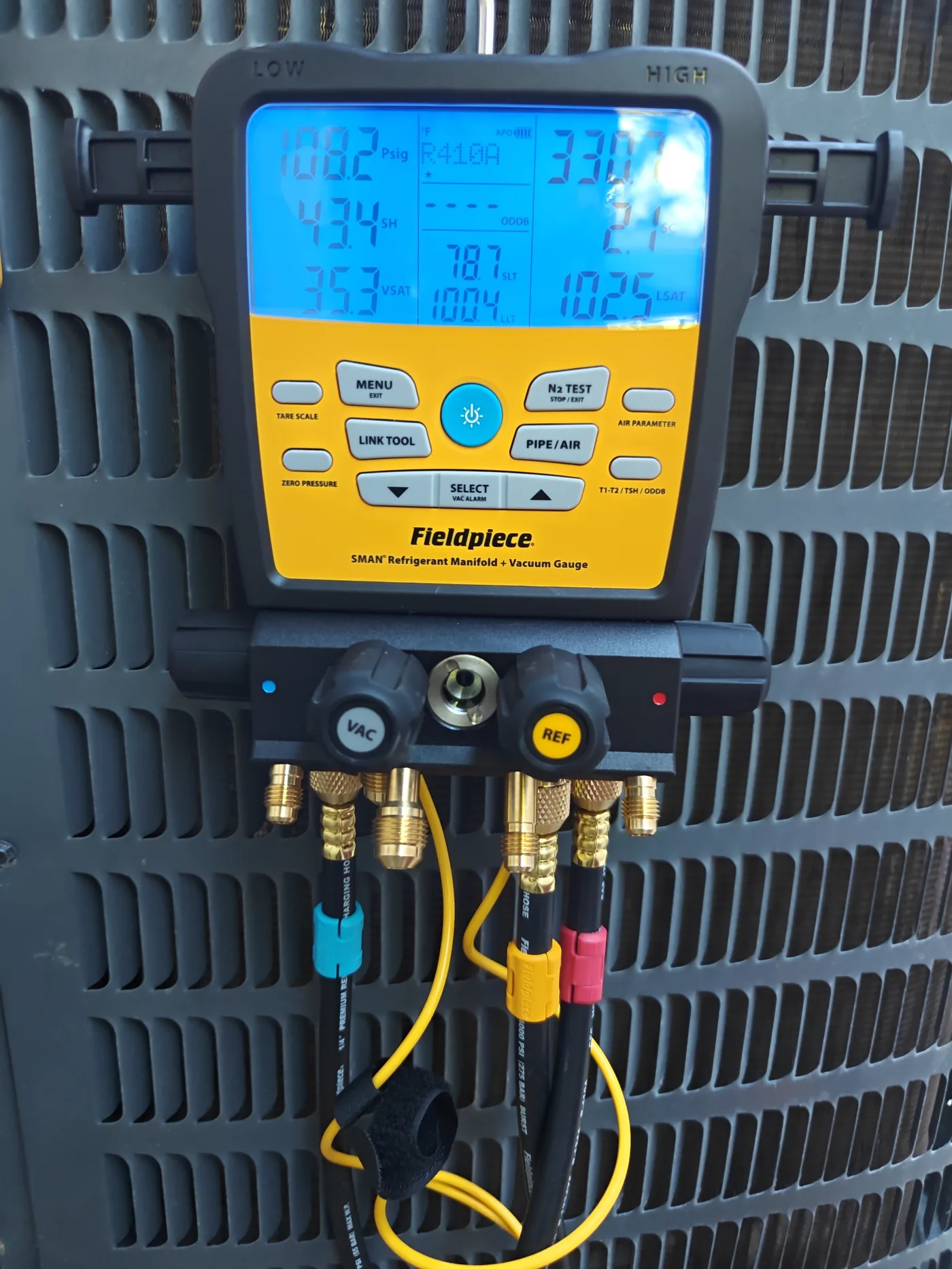 Charging an air conditioner with manifold gauges in Fresno