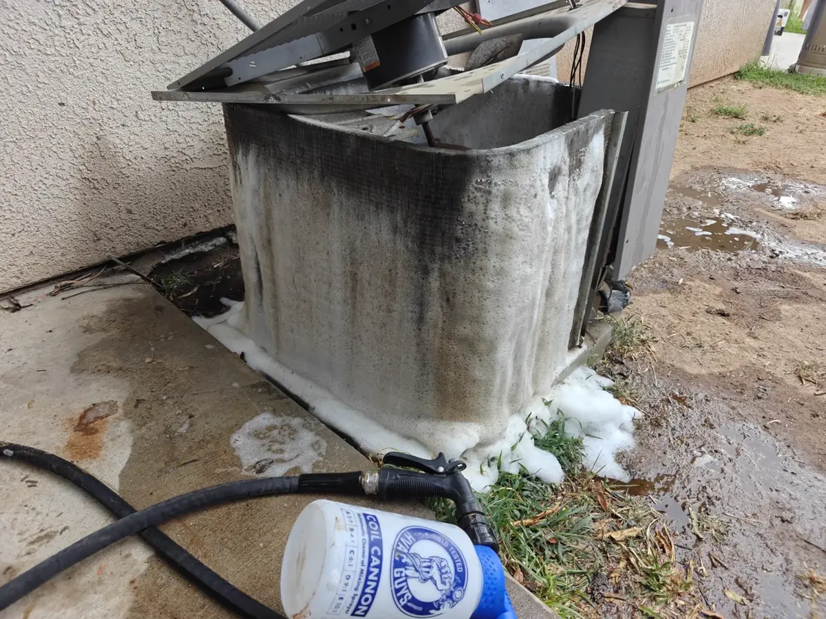 Outdoor condenser unit is taken apart, washed and sprayed down with a chemical solution